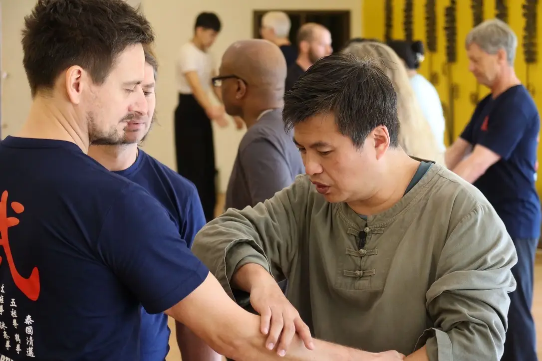 Sifu RIchard Huang working hands onwith student